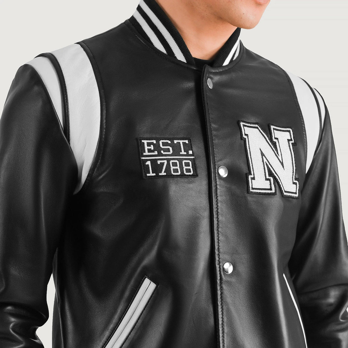 
Närbildsdetalj of Varsity & Snap Button Hardware on Liberte New York Svart Leather Varsity Läderjacka för Herr